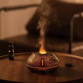 Round resin aroma diffuser with colourful flame effect lighting on desktop