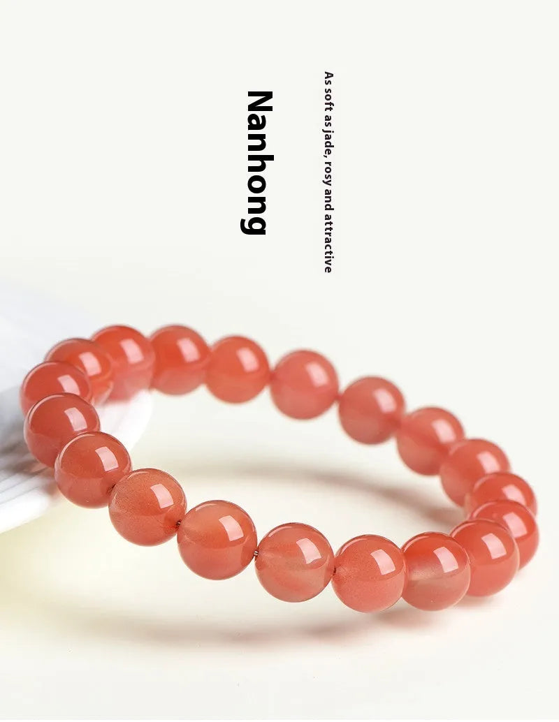 Natural South Red Cherry Agate bracelet on a wrist, showing polished beads in a single strand design.