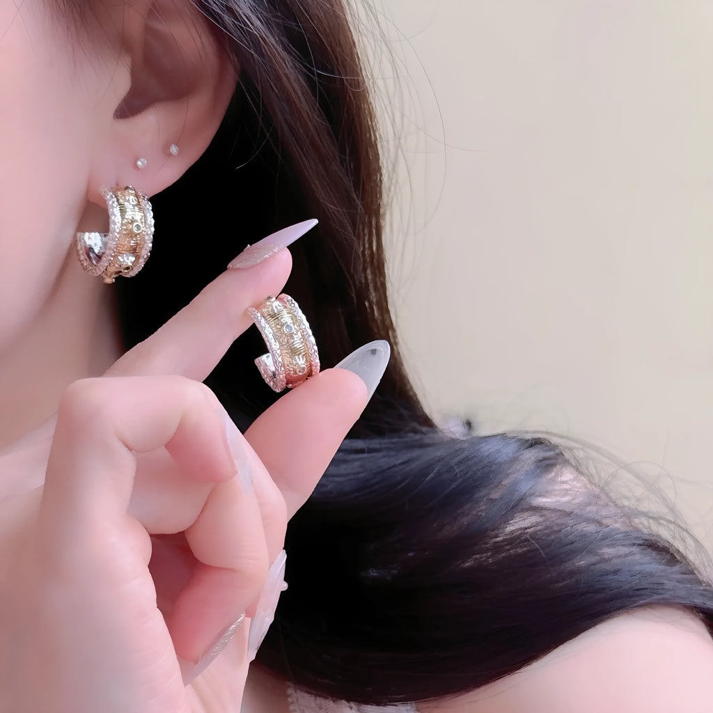 Gold and silver colour matching C-shaped brushed ring earrings with 925 silver needle on display