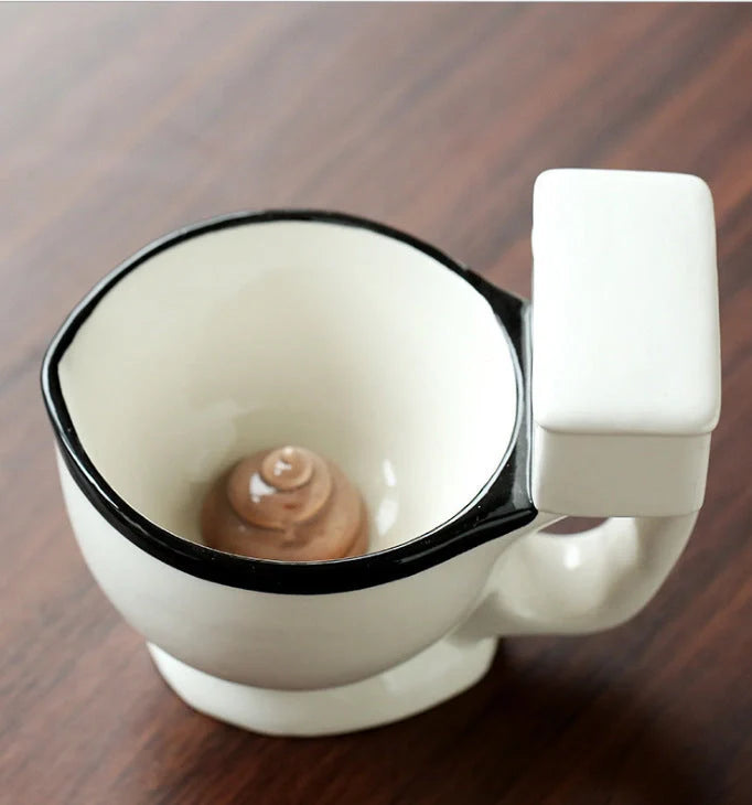Humorous toilet-shaped ceramic coffee mug with handgrip, perfect for gag gifts or unique decor