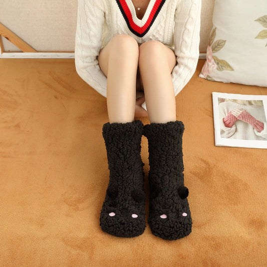 Cozy coral fleece socks in various colors, featuring a plush, insulating texture and non-slip grippy sole for comfortable home wear.