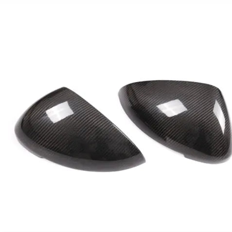 True carbon fibre exterior mirror covers for a Porsche Macan, shown in high-gloss black.