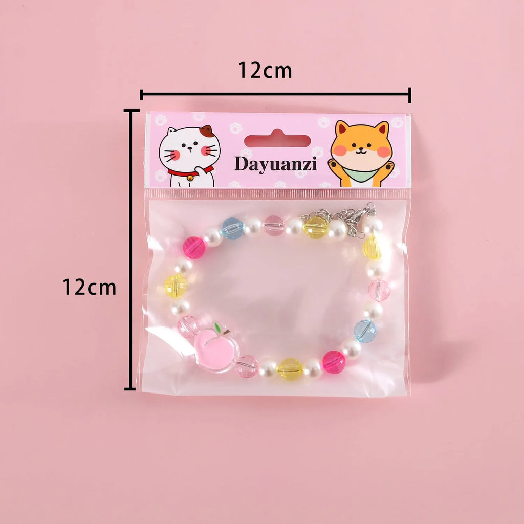 Colourful plastic bead necklace for cats in peach, rainbow, or small flower patterns with adjustable XS or S sizing