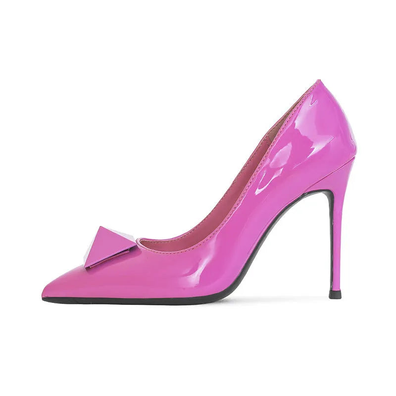 Pink women's patent leather pointed toe stiletto high heels with a buckle on the vamp.