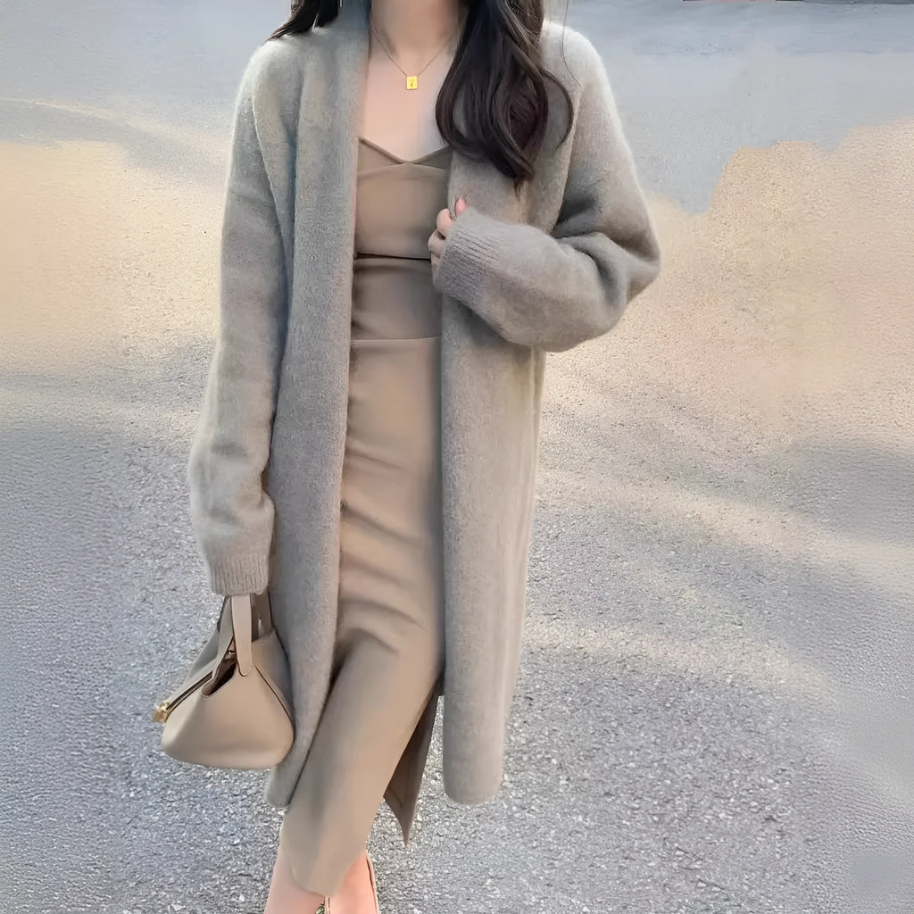 Women's khaki loose-fit knitted V-neck cardigan on a hanger, showing mid-length and long sleeves.