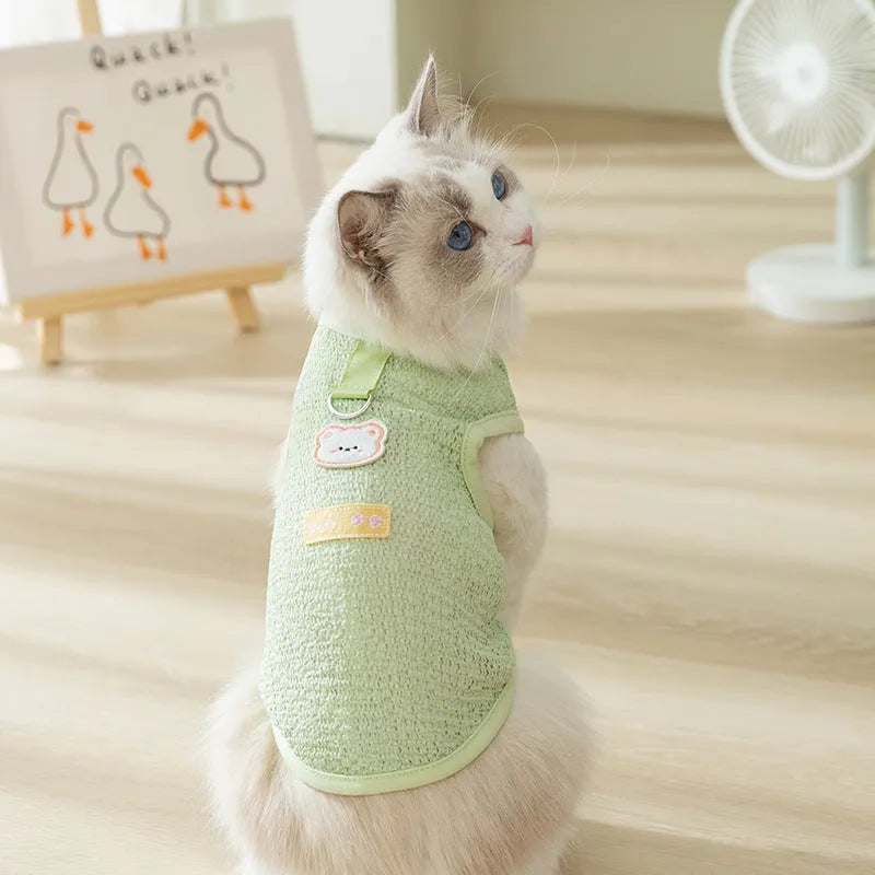 Green knitted cat clothing with a hollowed-out cartoon bear patch design