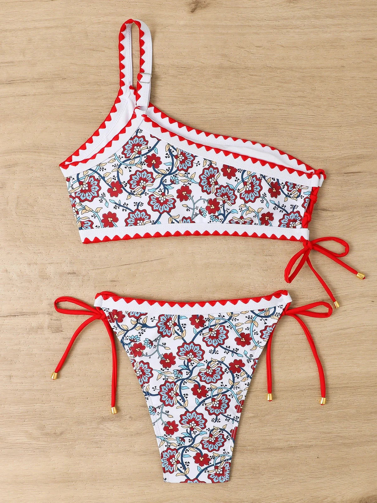 Women's blue floral one-shoulder bikini set with briefs-style bottom on mannequin