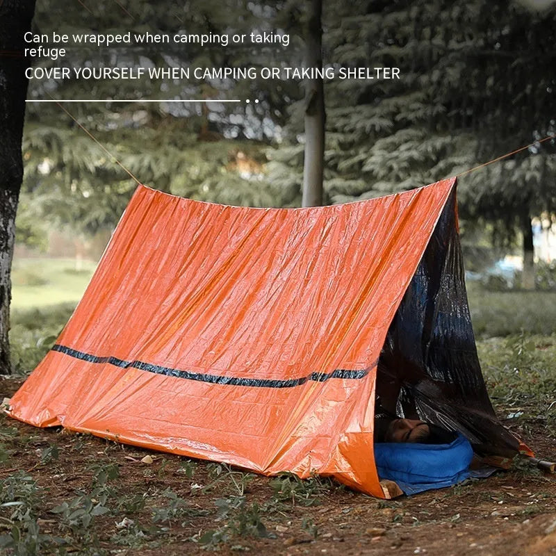 Emergency disaster relief tent kit with orange tent, sleeping bag, raincoat and safety whistle