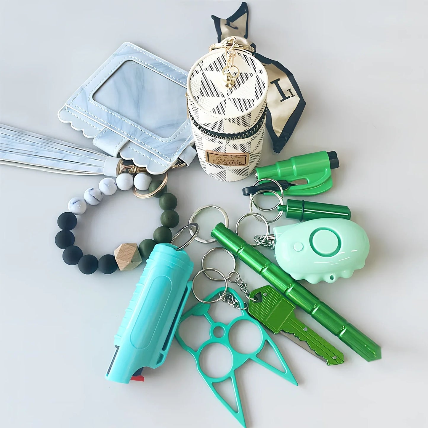 Green wrist strap self-defence key chain with perfume bottle, window breaker, alarm, and stick attachments, 10cm holder