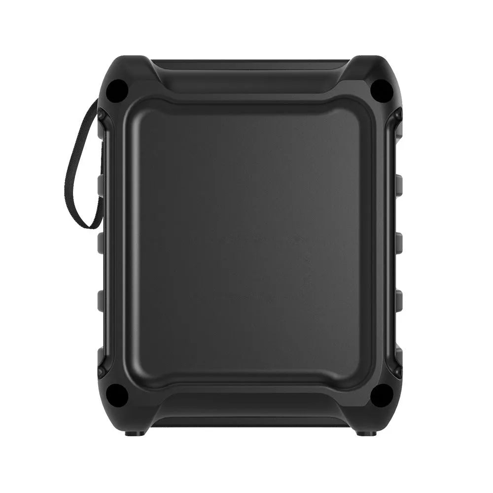 Compact portable Bluetooth speaker with USB charging cable on a desk.