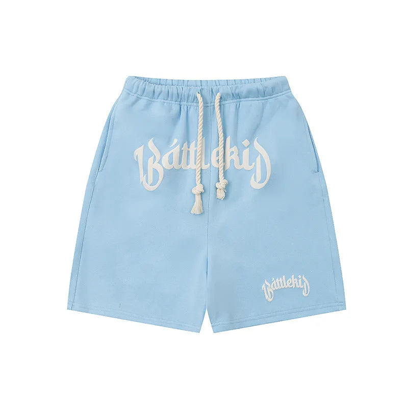 Cotton-blend loose-fit street shorts in black, shown in a casual setting.