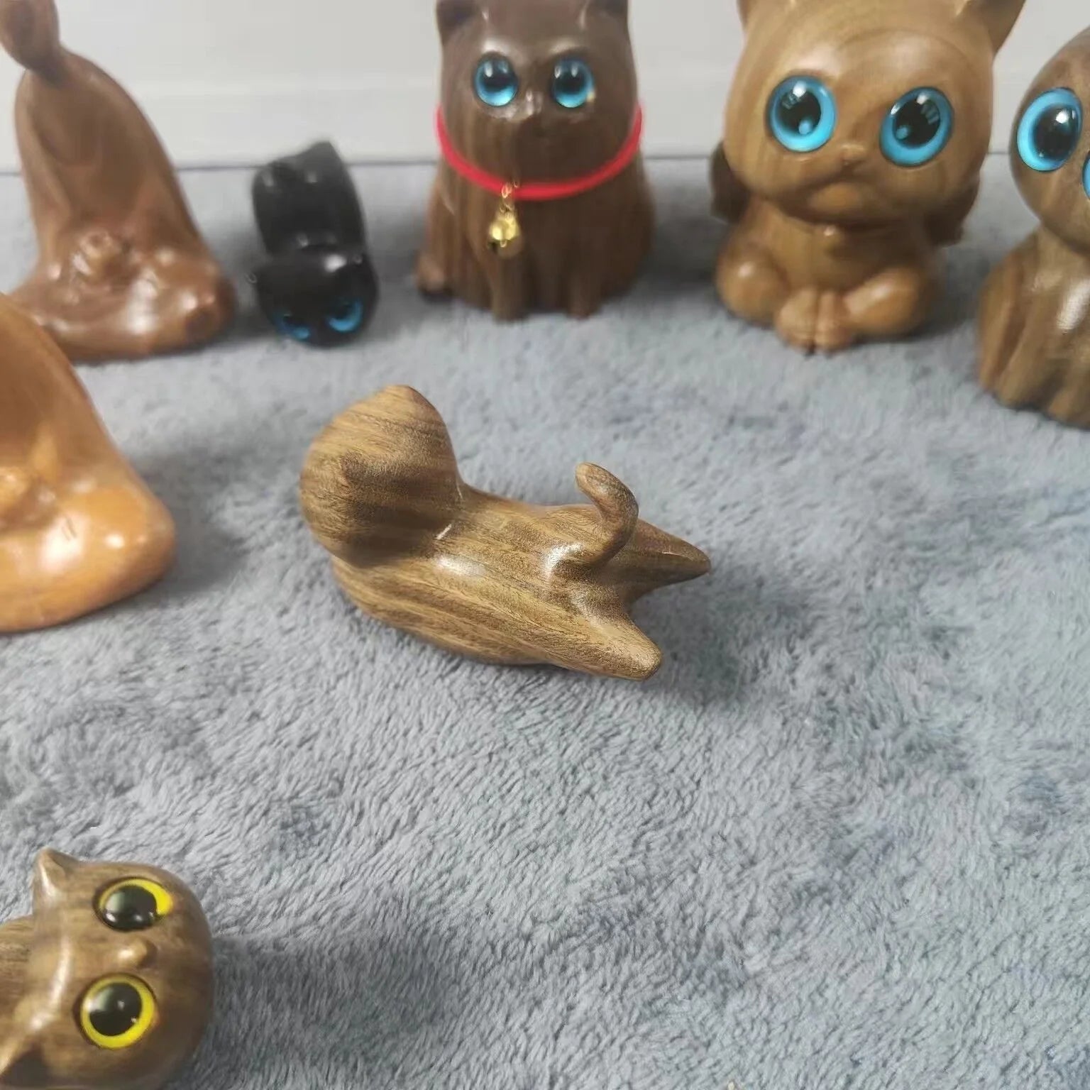 Handcrafted sandalwood kitten ornaments in various styles and colours