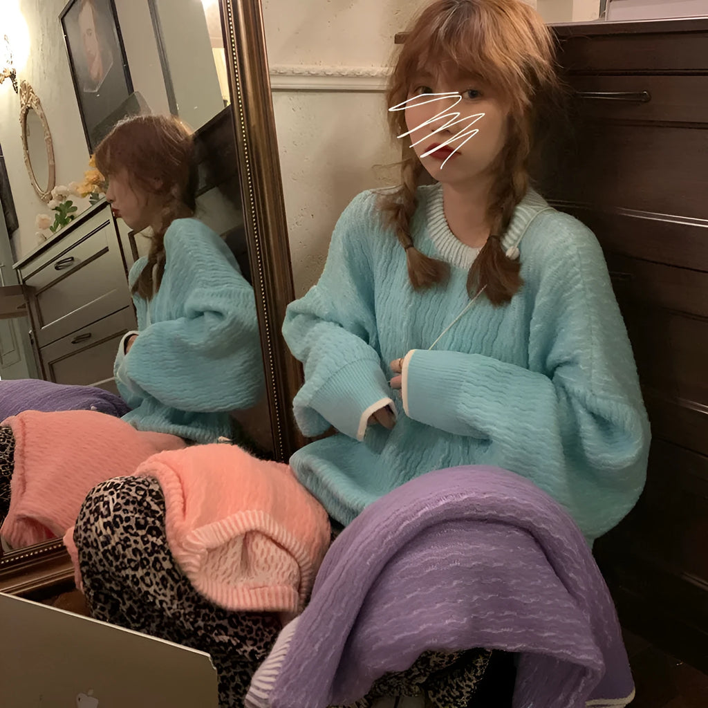 A woman's loose-fit pullover sweater in a solid lake blue colour with a retro style and regular sleeves.