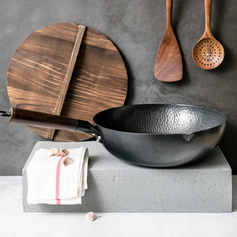 Traditional black iron wok pan with wooden handle measuring 40x32x10cm