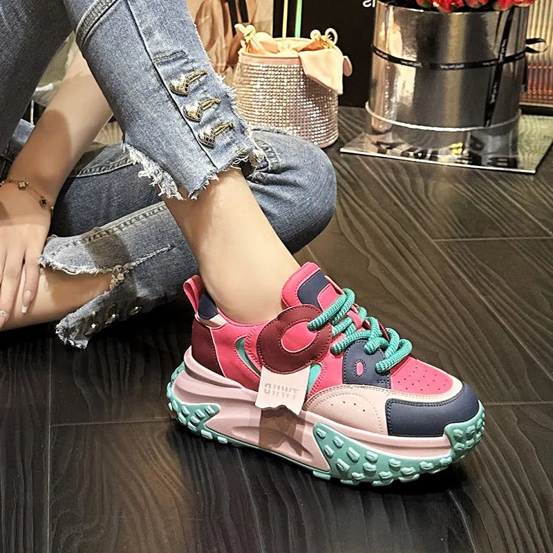 A pair of thick-soled leather casual shoes with a wedge heel and front lace-up, shown in one of the available colours.