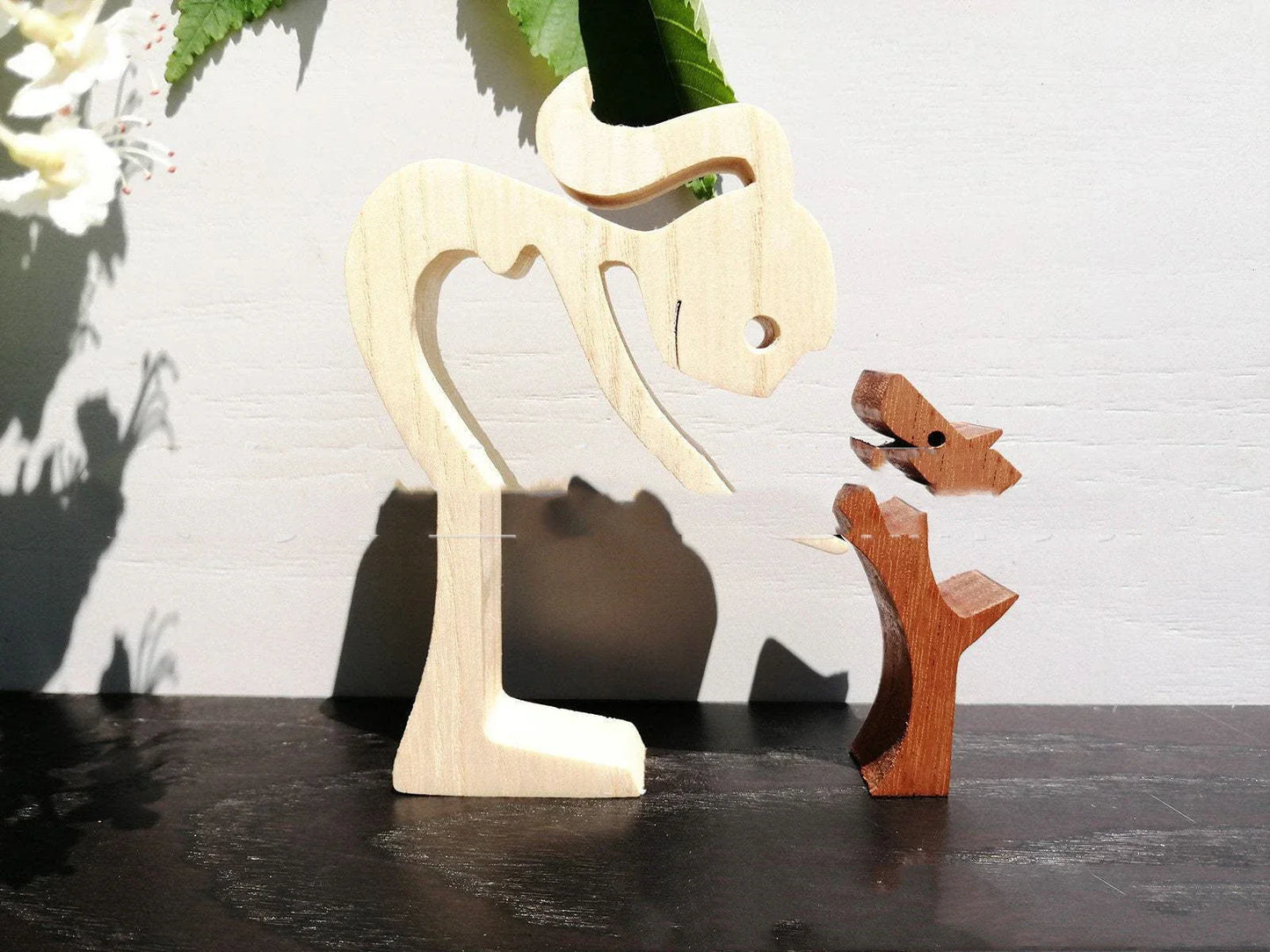 Handcrafted wooden dog sculpture featuring a man and his loyal canine companion