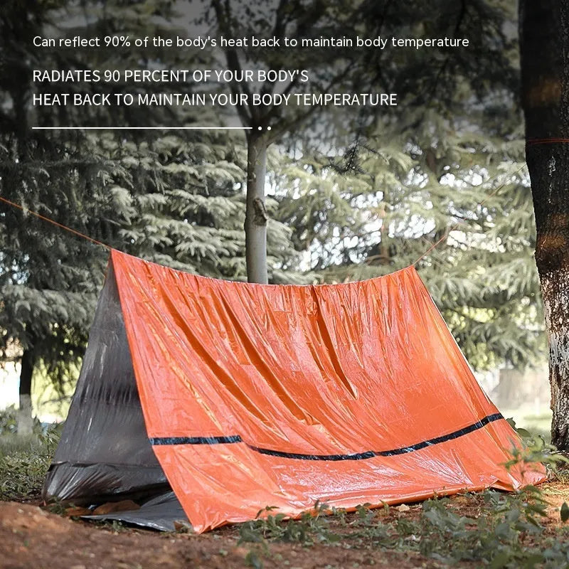 Emergency disaster relief tent kit with orange tent, sleeping bag, raincoat and safety whistle