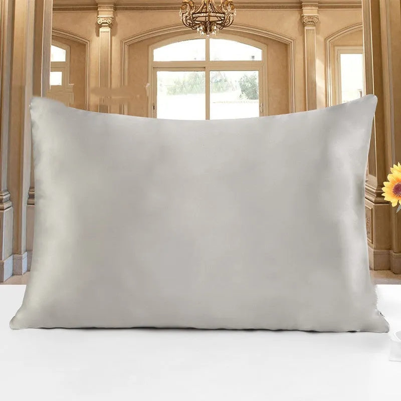 19 M double-sided silk pillowcase shown in one of 14 colours, including apricot, champagne, and navy blue.