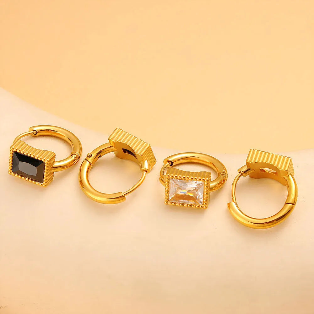 Square geometric stainless steel earrings with round rings and zircon accents, shown in white, black, and green colour options.