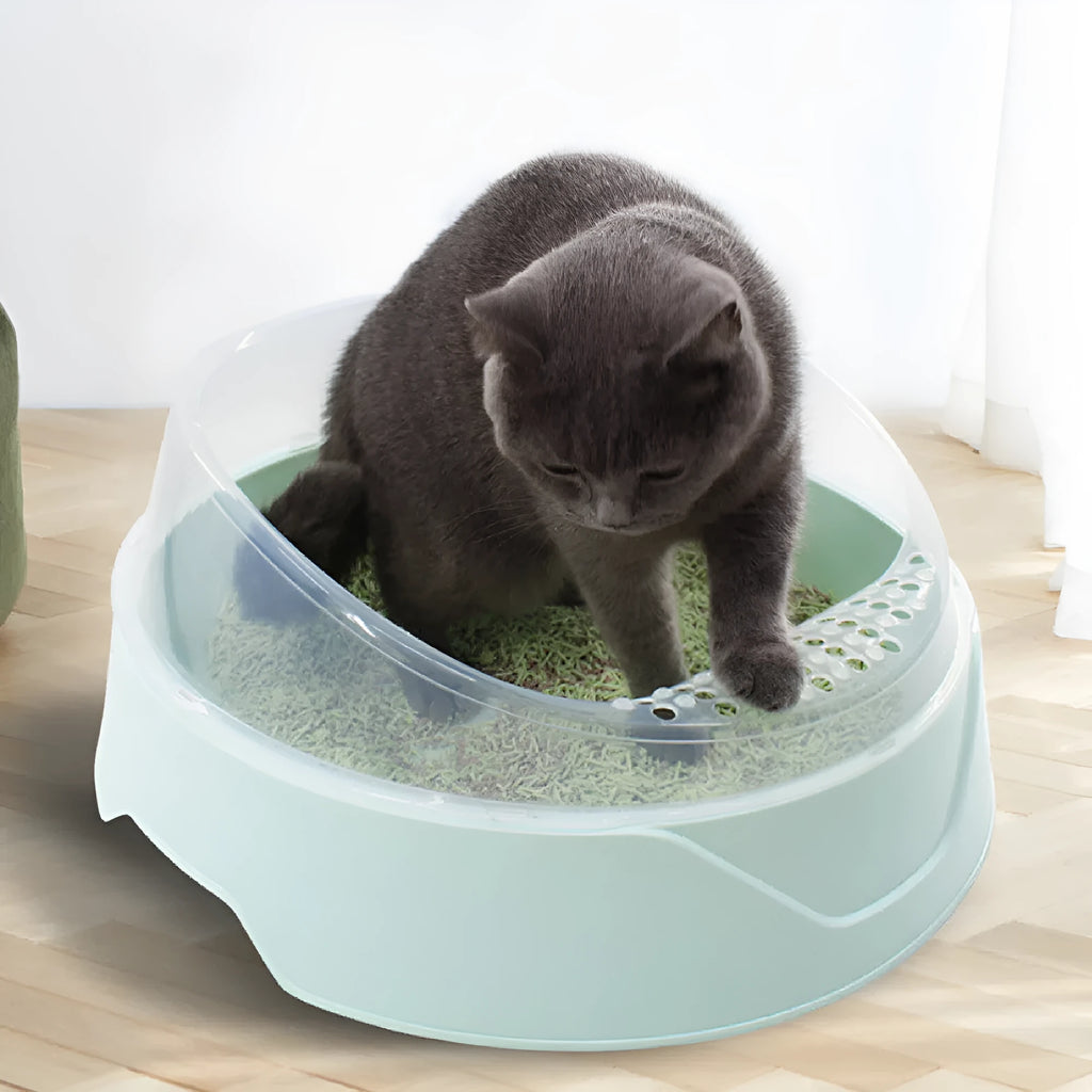 Round mint green cat litter box made from PP plastic on a wooden floor.