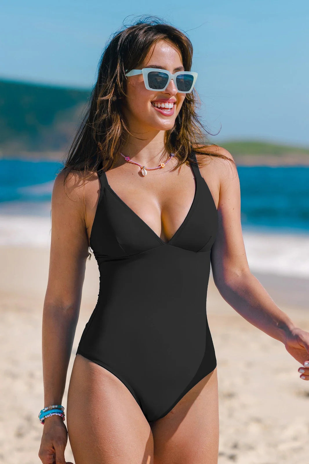 Women's solid colour V-neck one-piece swimsuit in black, red, blue, or green options