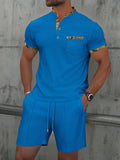 Man wearing a grey waffle-texture zip polo and matching shorts from a cotton blend summer suit set.