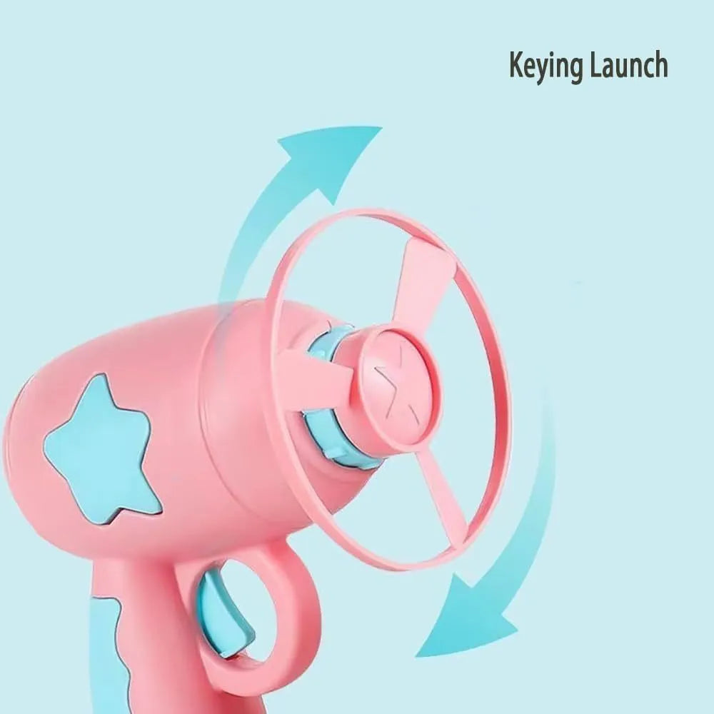 Blue interactive cat toy gun with a plastic frisbee on the launch head, shown next to a second pink frisbee.