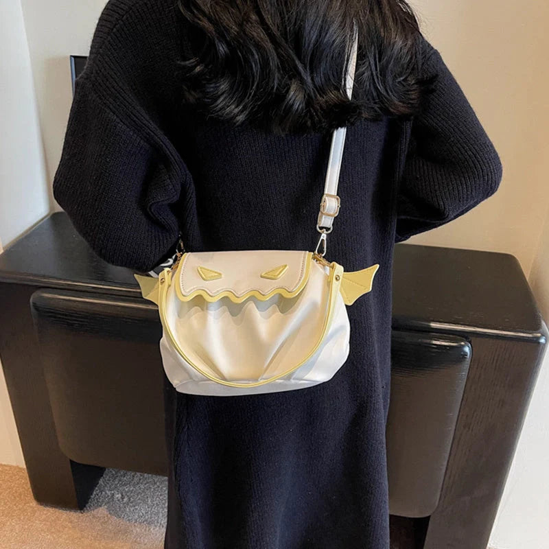 Halloween pumpkin cartoon crossbody bag with wings in black, white, and orange