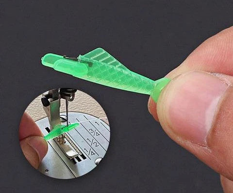Small fish design needle threader for sewing machines in green, metal and plastic construction