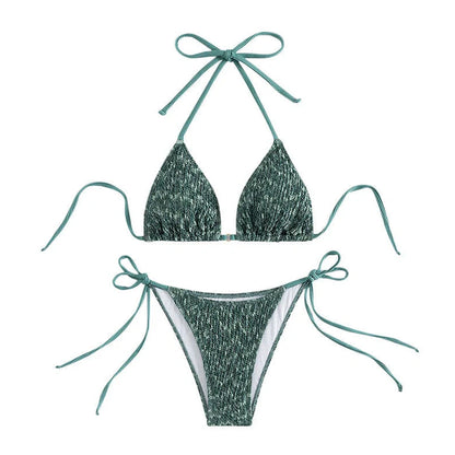 Green backless halter swimsuit with adjustable straps and matching shorts on mannequin