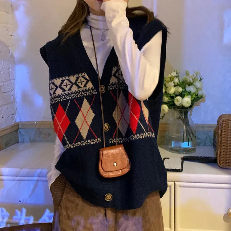 Khaki diamond plaid sleeveless cardigan on a hanger, showing loose fit and open front.