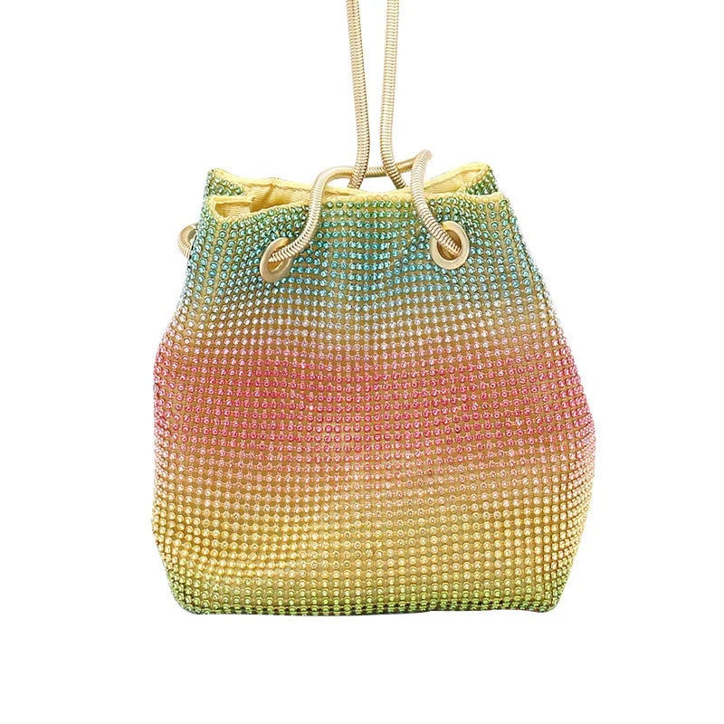 Sparkling rhinestone bucket bag with drawstring closure on a soft texture.