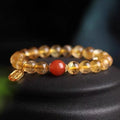 Red agate lucky bead bracelet with gold ruby accents showing polished natural stone beads