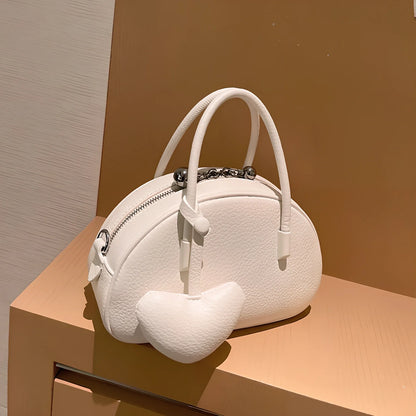 Women's heart-shaped crossbody bag in genuine leather with adjustable strap and zipper compartment