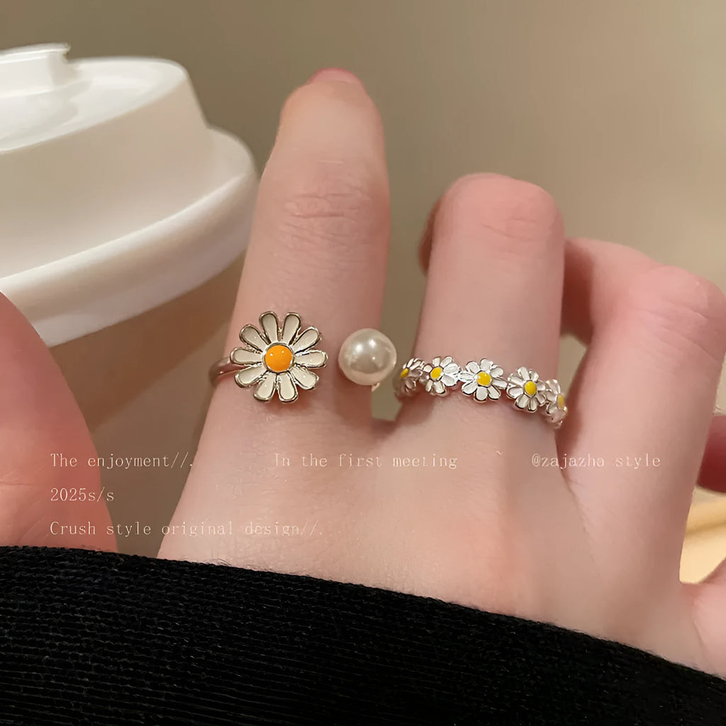 Women's adjustable copper ring set showing little daisy pearl ring and plain daisy ring with opening design.