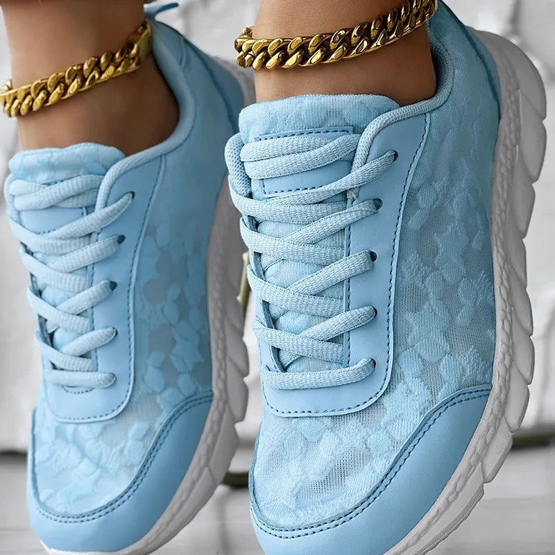 Women's white canvas casual running shoes with soft flat soles on a light background.