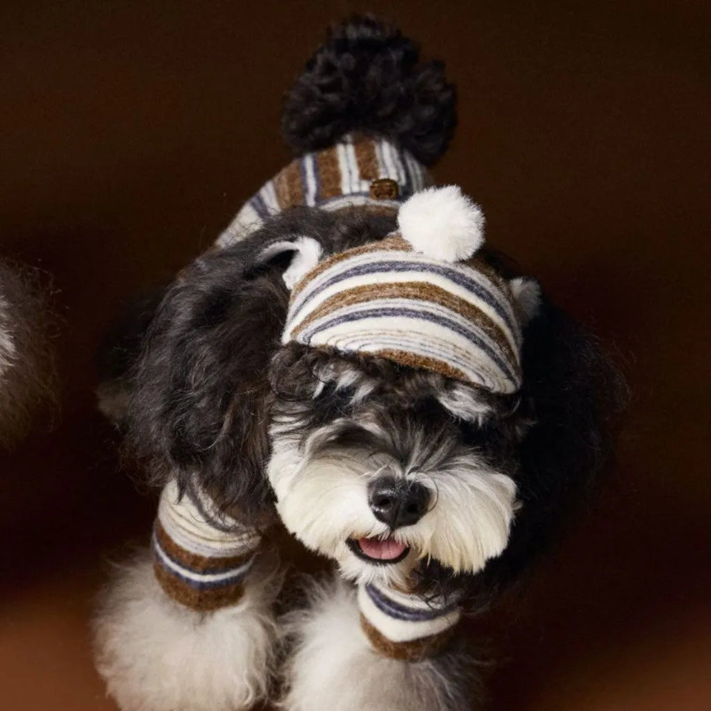 Striped fur ball acrylic dog hat in pink and coffee colours on display showing side view
