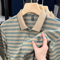 A man wearing a red, blue, or green striped short sleeve casual shirt with a mosaic pattern detail.
