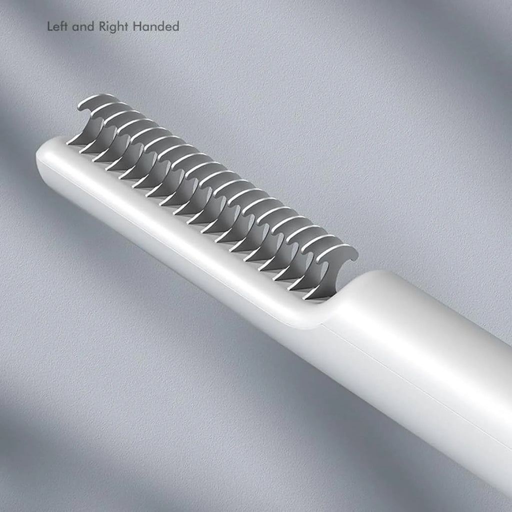 Stainless steel dog dematting comb with ergonomic handle on a pink background