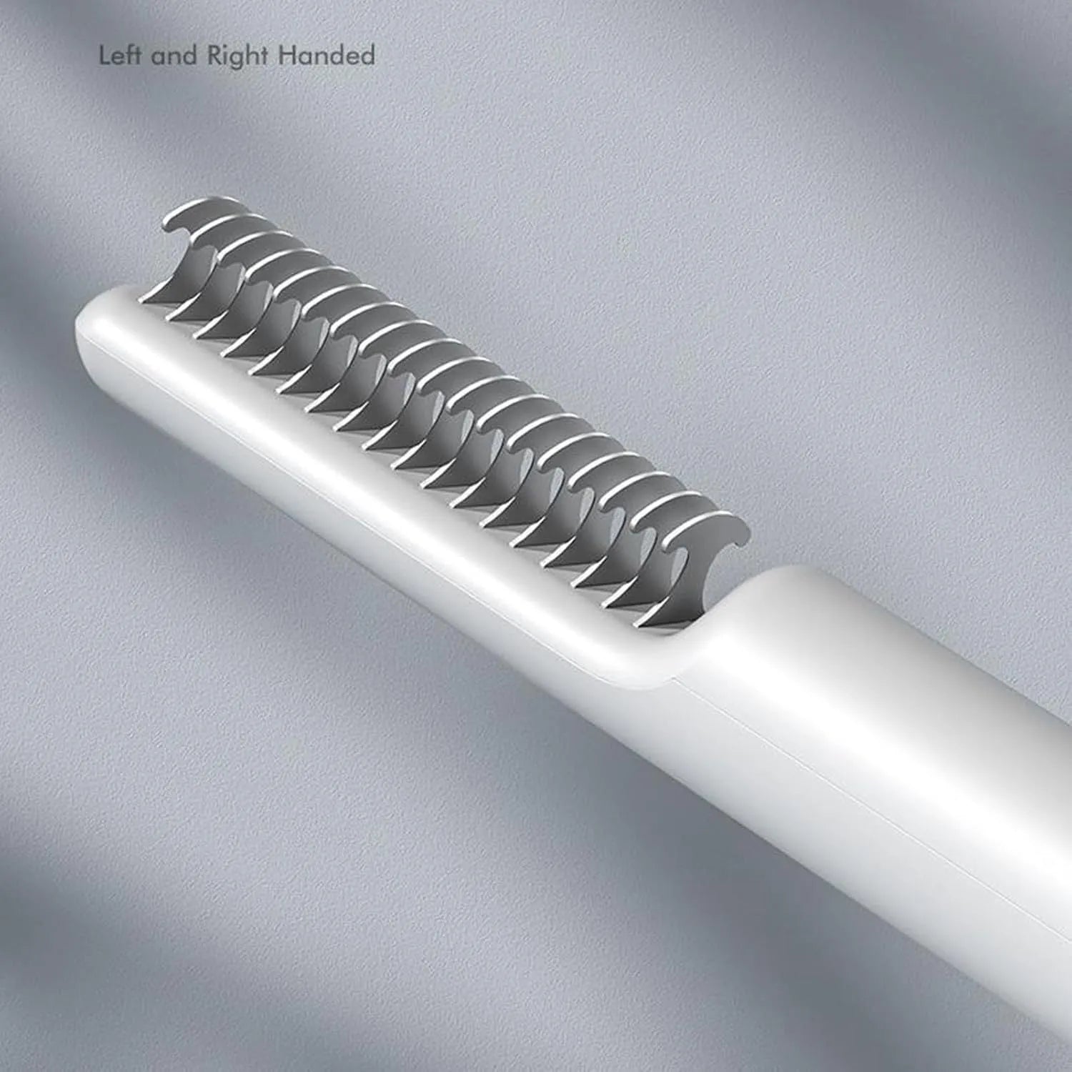 Stainless steel dog dematting comb with ergonomic handle on a pink background