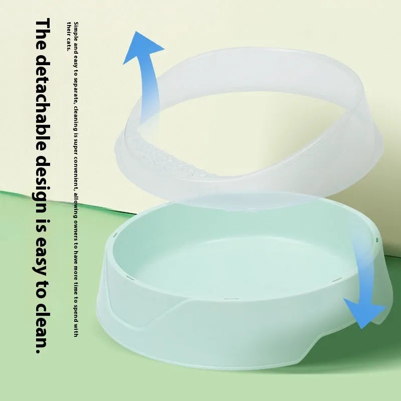 Round mint green cat litter box made from PP plastic on a wooden floor.
