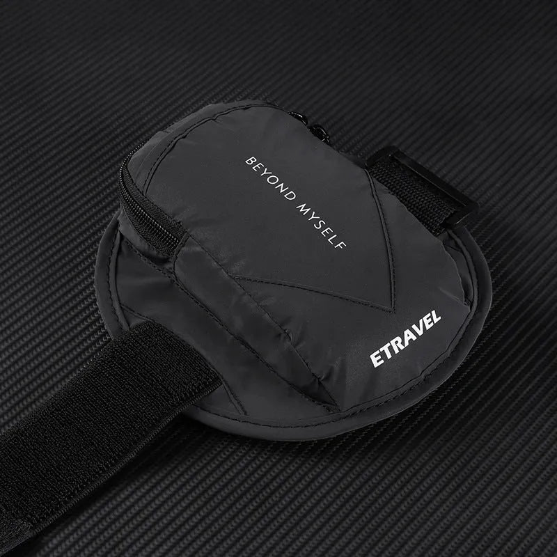 Reflective black running arm bag with adjustable strap shown on an arm.