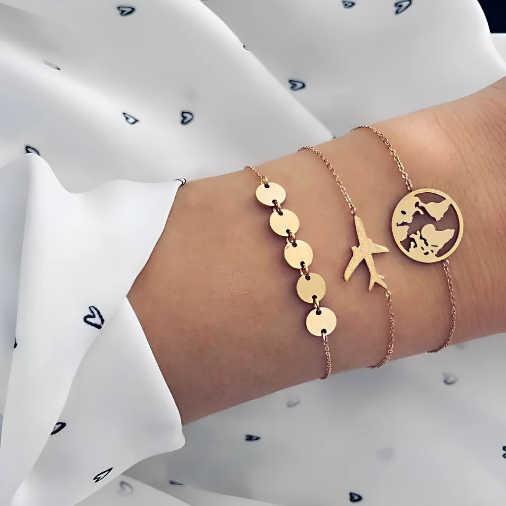 Set of three bohemian-style women's bracelets with heart-shaped aircraft map charms in alloy.