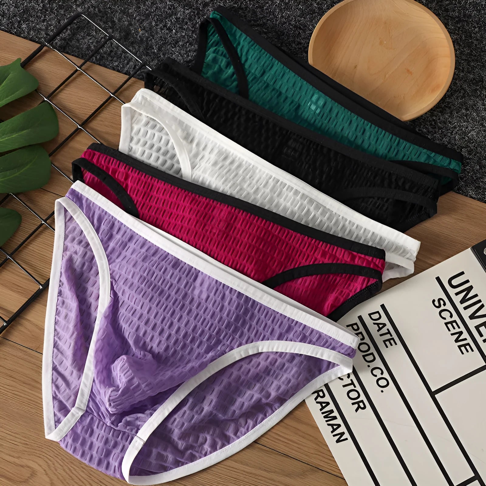 Men's low waist transparent nylon lace underwear in a solid colour with text print.