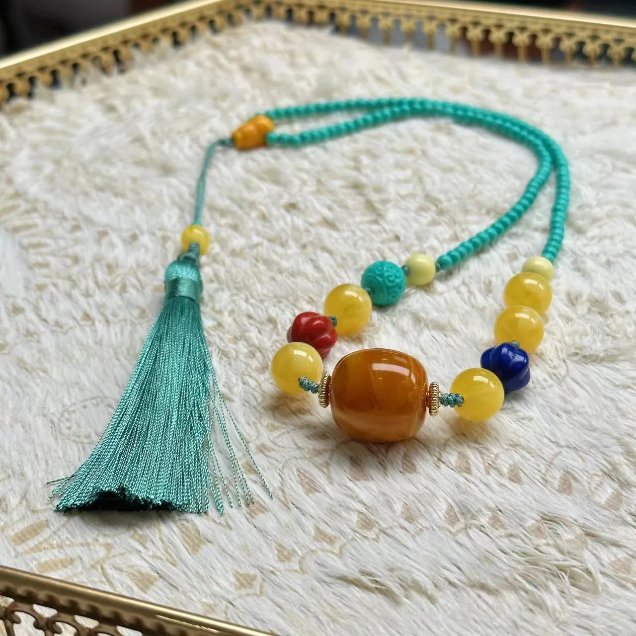 Turquoise mesh flower pendant on an adjustable ball bead necklace chain.