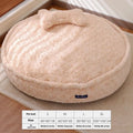 Milk tea colour round pet bed with a removable cloth cover on a wooden floor.