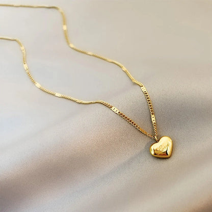 Vintage gold-toned love heart pendant necklace on a sectional chain