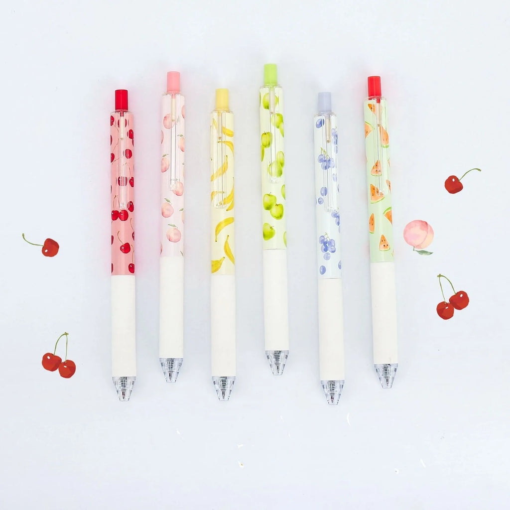 Three scented fruit ballpoint pens with press-action mechanism showing extended writing tips