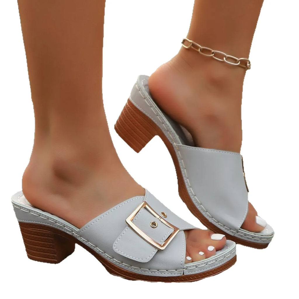 Women's black retro chunky heel slippers with a silver metal buckle on the strap.
