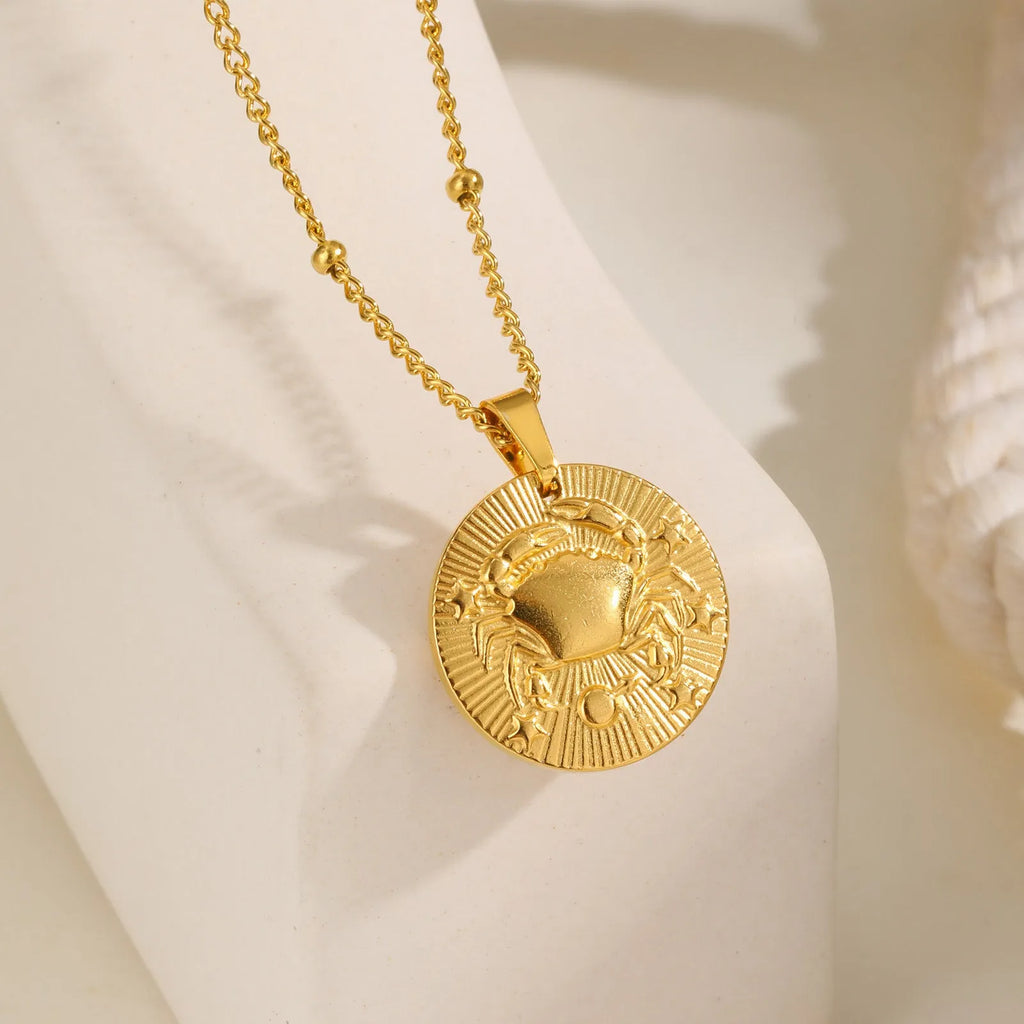 Silver stainless steel zodiac necklace with geometric round pendant showing embossed constellation design